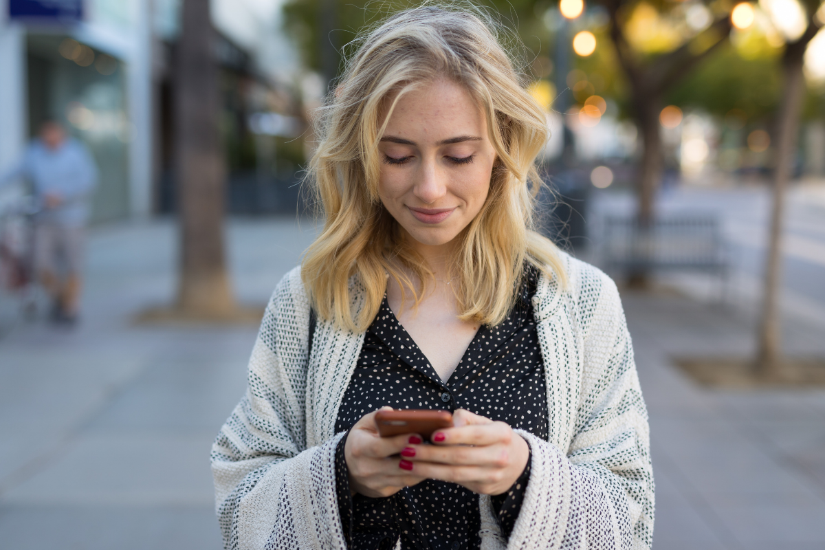 woman texting a business