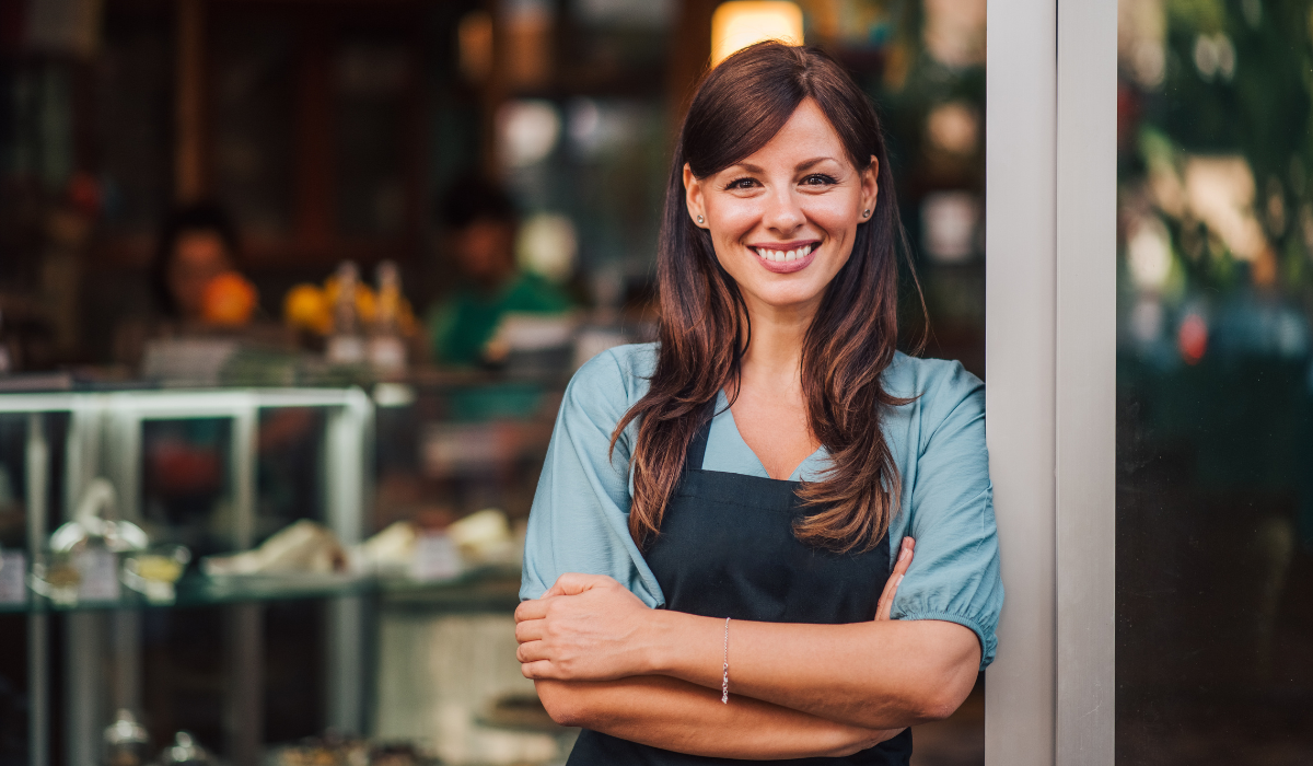 Small business owner in front of her shop